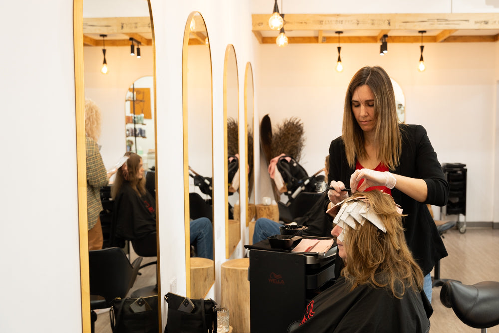 woman getting hair shampooed in salon